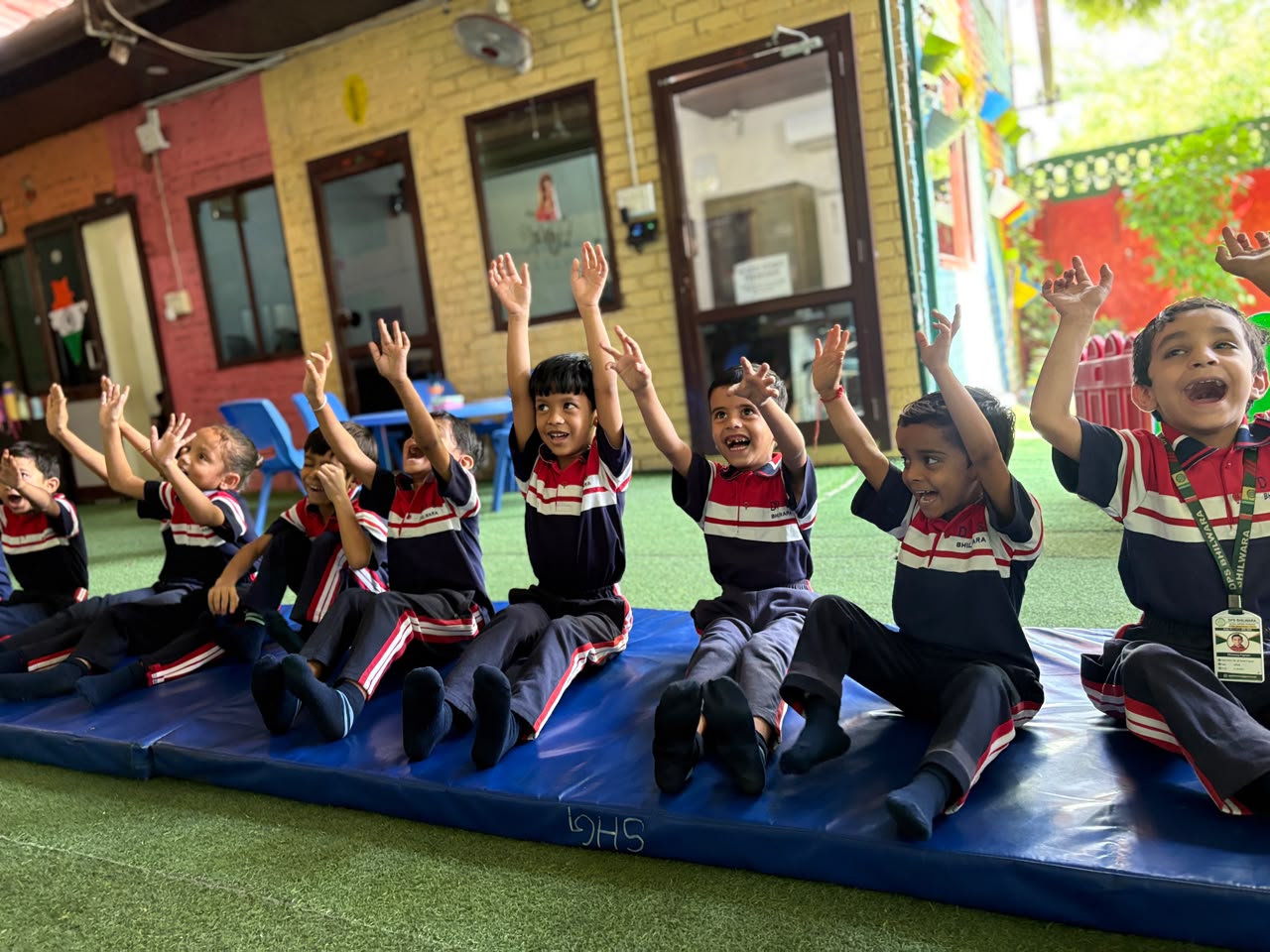 Happy Junior Wing students waving during an activity