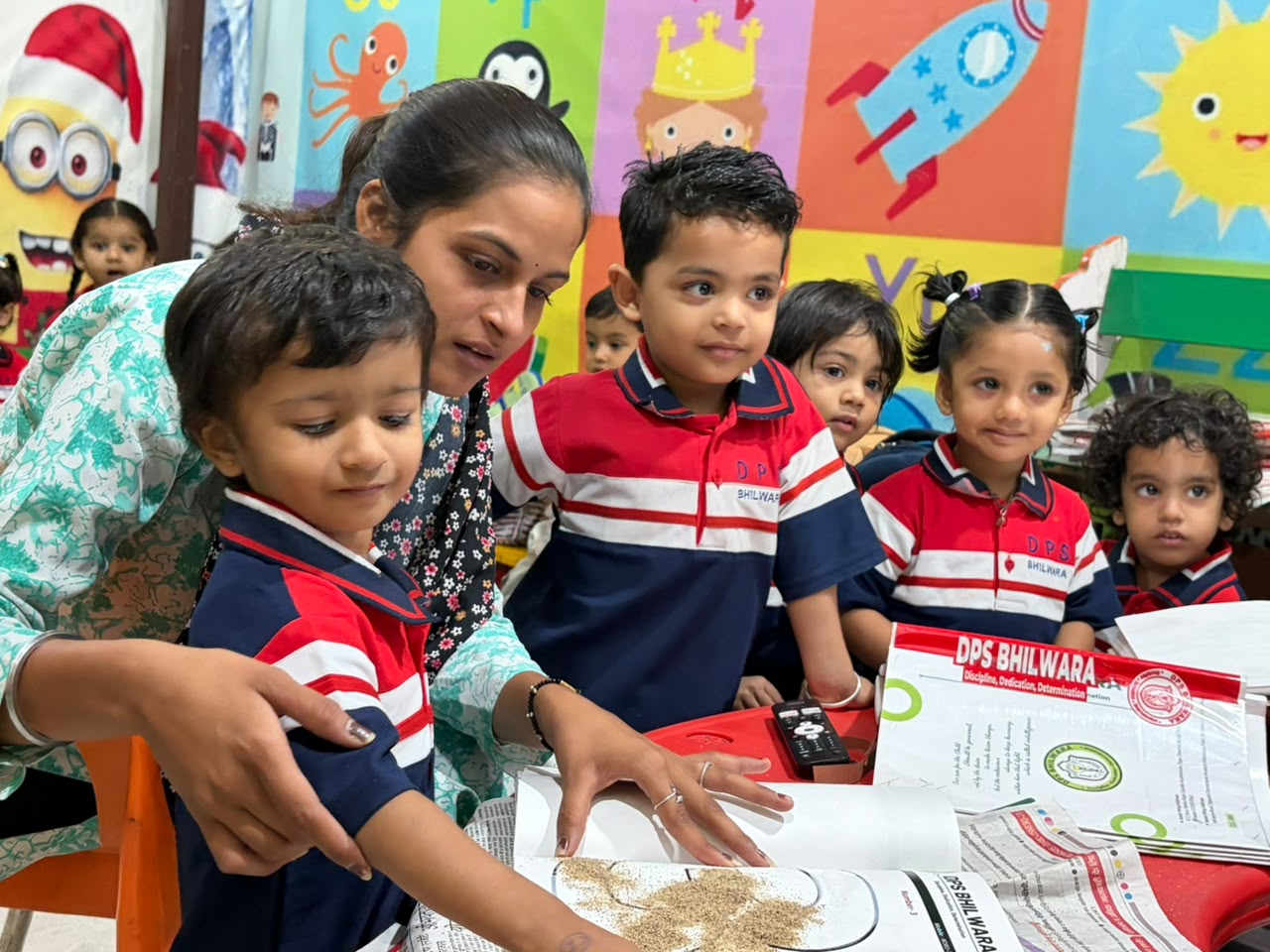 Teacher guiding students through a sand craft activity