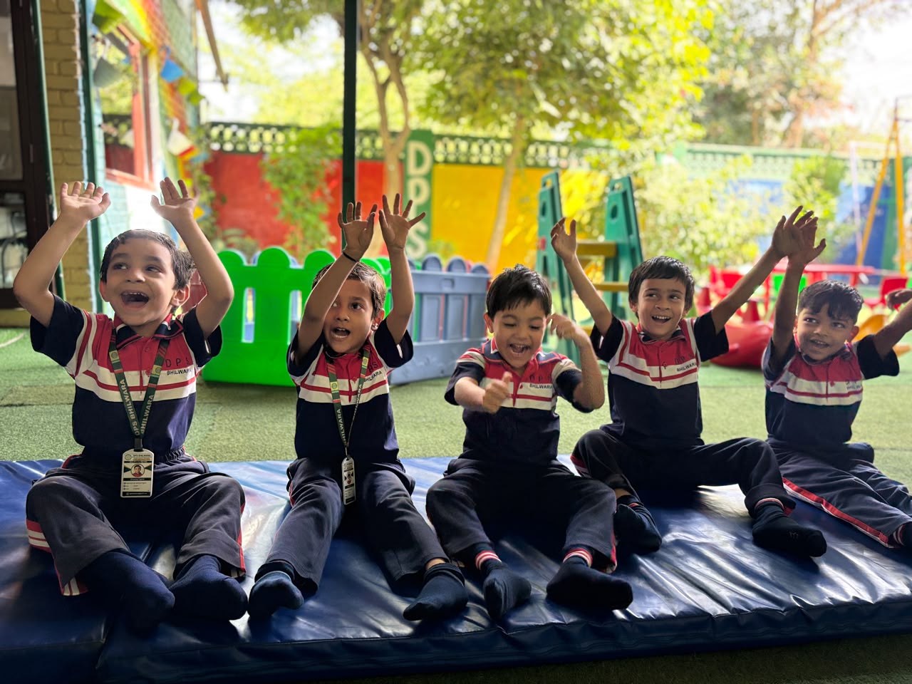 Junior Wing students cheering with raised hands