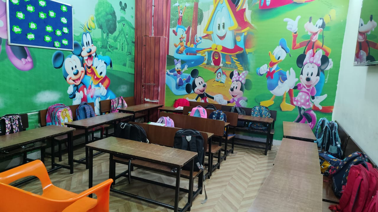 Junior Wing classroom with colourful cartoon wall mural