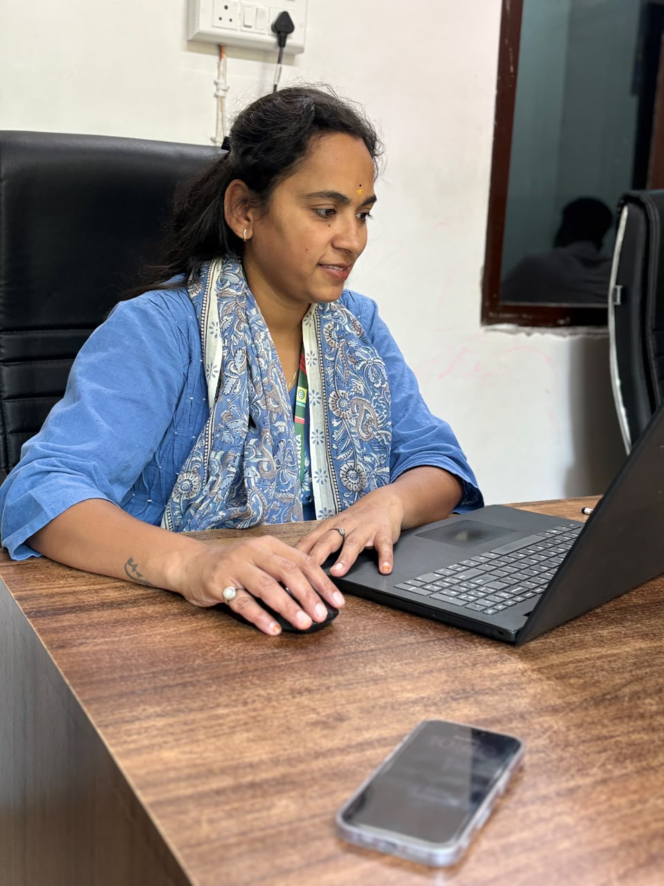 Teacher working on a laptop at her desk at DPS Bhilwara