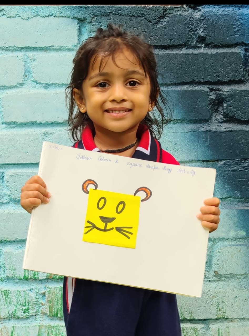 Student showing a yellow bear craft